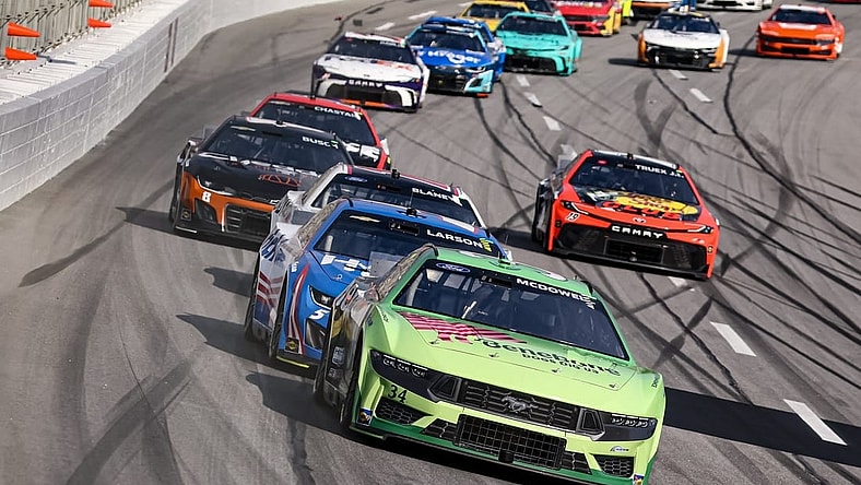 Feb 25, 2024; Hampton, Georgia, USA; NASCAR Cup Series driver Michael McDowell (34) battles with NASCAR Cup Series driver Kyle Larson (5) during the Ambetter Health 400 at Atlanta Motor Speedway. Mandatory Credit: David Yeazell-USA TODAY Sports