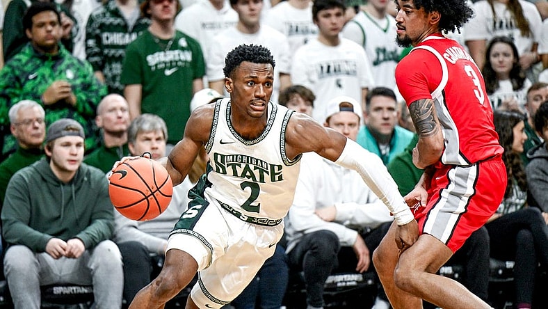 Michigan State's Tyson Walker, left, moves past Ohio State's Taison Chatman during the first half on Sunday, Feb. 25, 2024, at the Breslin Center in East Lansing.