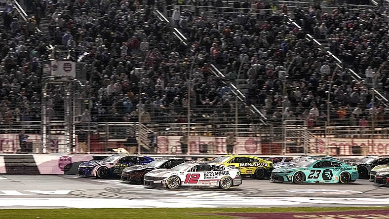 Feb 25, 2024; Hampton, Georgia, USA; NASCAR Cup Series driver Daniel Suarez (99) (near wall) beats NASCAR Cup Series driver Ryan Blaney (12) to the line to win the Ambetter Health 400 at Atlanta Motor Speedway. Mandatory Credit: David Yeazell-USA TODAY Sports