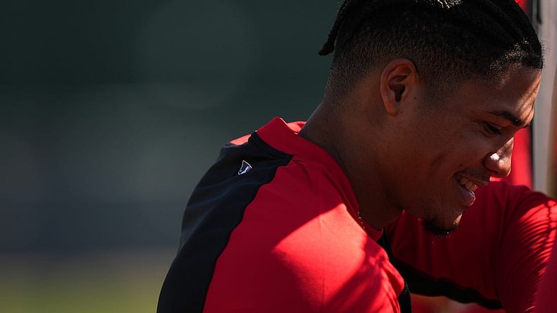 Cincinnati Reds shortstop Noelvi Marte (16) smiles while waiting for his turn to take batting practice during spring training workouts, Thursday, Feb. 15, 2024, at the team   s spring training facility in Goodyear, Ariz.