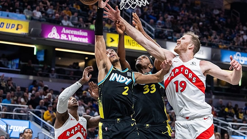 Feb 26, 2024; Indianapolis, Indiana, USA; Indiana Pacers guard Andrew Nembhard (2) shoots the ball while Toronto Raptors center Jakob Poeltl (19) defends in the second half at Gainbridge Fieldhouse. Mandatory Credit: Trevor Ruszkowski-USA TODAY Sports