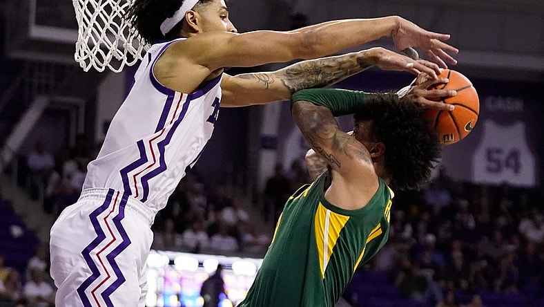 Feb 26, 2024; Fort Worth, Texas, USA; TCU Horned Frogs guard Micah Peavy (0) defends Baylor Bears forward Jalen Bridges (11) during the second half at Ed and Rae Schollmaier Arena. Mandatory Credit: Raymond Carlin III-USA TODAY Sports
