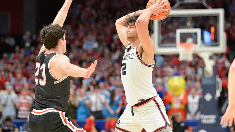 Feb 27, 2024; Dayton, Ohio, USA;  Dayton Flyers forward Nate Santos (2) passes the ball against Davidson Wildcats guard Connor Kochera (23) during the second half of the game at University of Dayton Arena. Mandatory Credit: Matt Lunsford-USA TODAY Sports