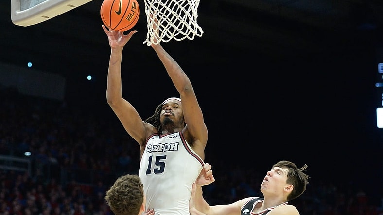 Feb 27, 2024; Dayton, Ohio, USA;  Dayton Flyers forward DaRon Holmes II (15) shoots the ball against Davidson Wildcats  guard Achile Spadone (3) and forward Sean Logan (15) during the second half of the game at University of Dayton Arena. Mandatory Credit: Matt Lunsford-USA TODAY Sports