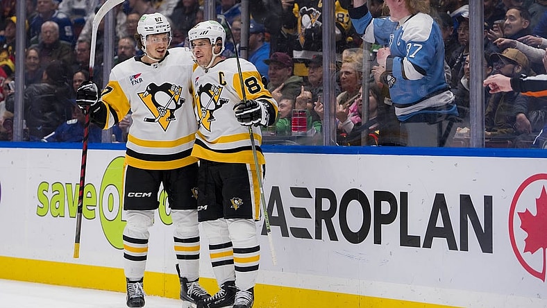 Feb 27, 2024; Vancouver, British Columbia, CAN; Pittsburgh Penguins forward Rickard Rakell (67) and forward Sidney Crosby (87) celebrate Rakell   s second goal of the game against the Vancouver Canucks in the second period at Rogers Arena. Mandatory Credit: Bob Frid-USA TODAY Sports