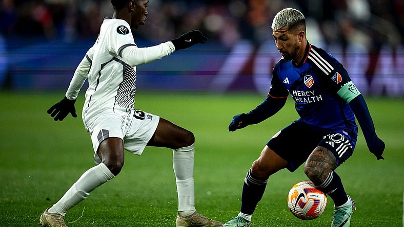 FC Cincinnati midfielder Luciano Acosta (10) handles the ball as Cavalier FC midfielder Dwayne Allen (13) guards him in the second half of the MLS match between the FC Cincinnati and the Cavalier FC at TQL Stadium in Cincinnati on Wednesday, Feb. 28, 2024.