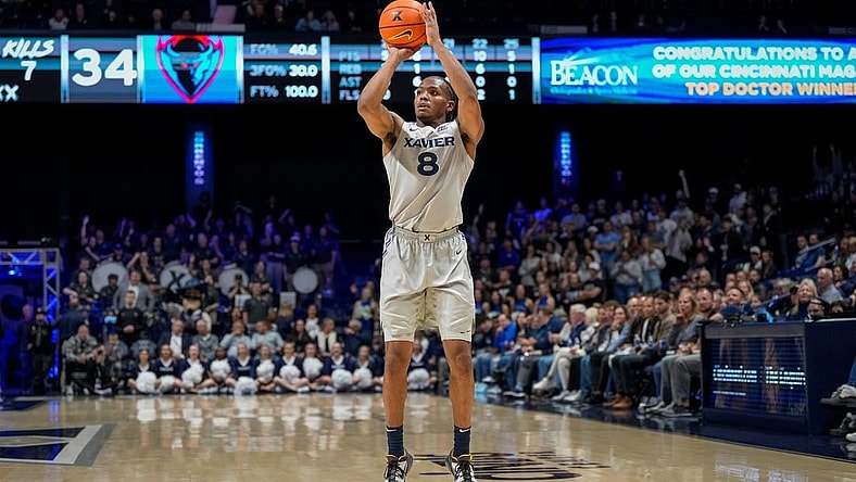 Xavier Musketeers guard Quincy Olivari (8) scores from three point range in the second half of the NCAA Big East conference basketball game between the Xavier Musketeers and the DePaul Blue Demons at the Cintas Center in Cincinnati on Wednesday, Feb. 28, 2024.