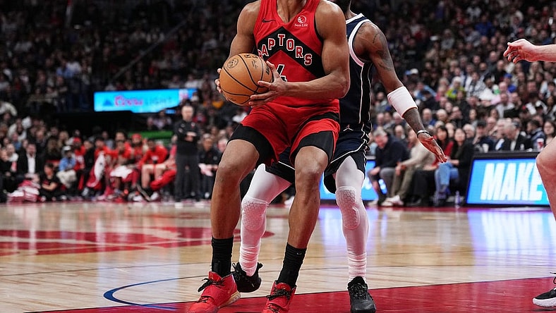 Feb 28, 2024; Toronto, Ontario, CAN; Toronto Raptors forward Scottie Barnes (4) controls the ball as Dallas Mavericks guard Kyrie Irving (11) tries to defend during the fourth quarter at Scotiabank Arena. Mandatory Credit: Nick Turchiaro-USA TODAY Sports