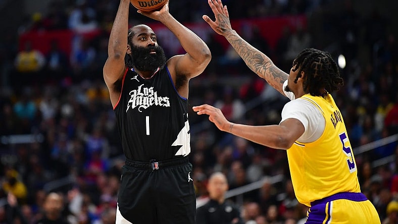 Feb 28, 2024; Los Angeles, California, USA; Los Angeles Clippers guard James Harden (1) shoots against Los Angeles Lakers forward Cam Reddish (5) during the second half at Crypto.com Arena. Mandatory Credit: Gary A. Vasquez-USA TODAY Sports