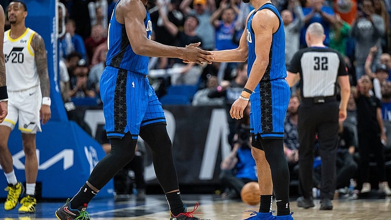 Feb 29, 2024; Orlando, Florida, USA; Orlando Magic center Wendell Carter Jr. (34) and guard Jalen Suggs (4) celebrate a three pointer against the Utah Jazz in the fourth quarter at Kia Center. Mandatory Credit: Jeremy Reper-USA TODAY Sports