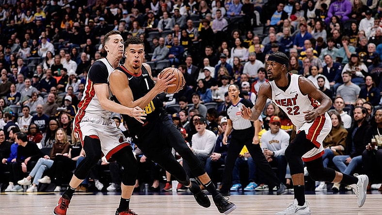 Feb 29, 2024; Denver, Colorado, USA; Denver Nuggets forward Michael Porter Jr. (1) drives to the basket against Miami Heat forward Duncan Robinson (55) in the first quarter at Ball Arena. Mandatory Credit: Isaiah J. Downing-USA TODAY Sports
