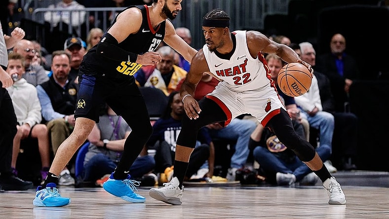Feb 29, 2024; Denver, Colorado, USA; Miami Heat forward Jimmy Butler (22) controls the ball as Denver Nuggets guard Jamal Murray (27) guards in the first quarter at Ball Arena. Mandatory Credit: Isaiah J. Downing-USA TODAY Sports