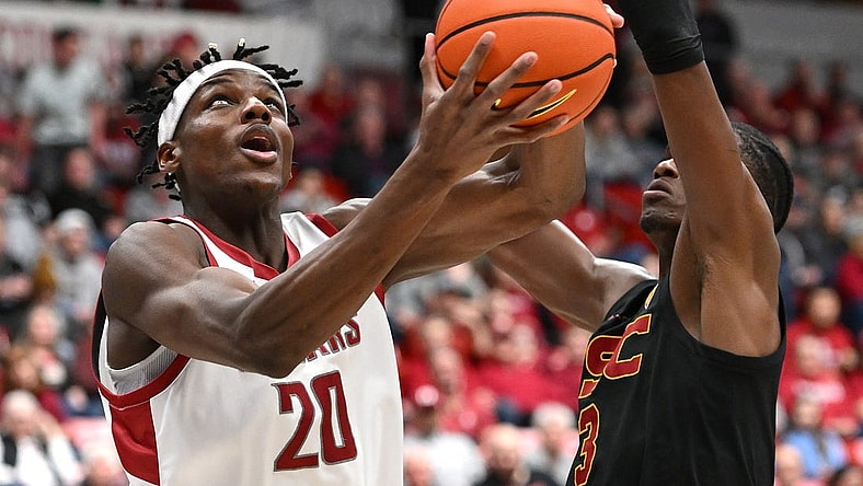 Feb 29, 2024; Pullman, Washington, USA; Washington State Cougars center Rueben Chinyelu (20) shoots the ball against USC Trojans forward Vincent Iwuchukwu (3) in the first half at Friel Court at Beasley Coliseum. Mandatory Credit: James Snook-USA TODAY Sports