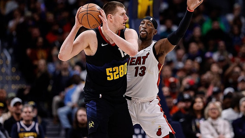 Feb 29, 2024; Denver, Colorado, USA; Denver Nuggets center Nikola Jokic (15) controls the ball as Miami Heat center Bam Adebayo (13) guards in the fourth quarter at Ball Arena. Mandatory Credit: Isaiah J. Downing-USA TODAY Sports