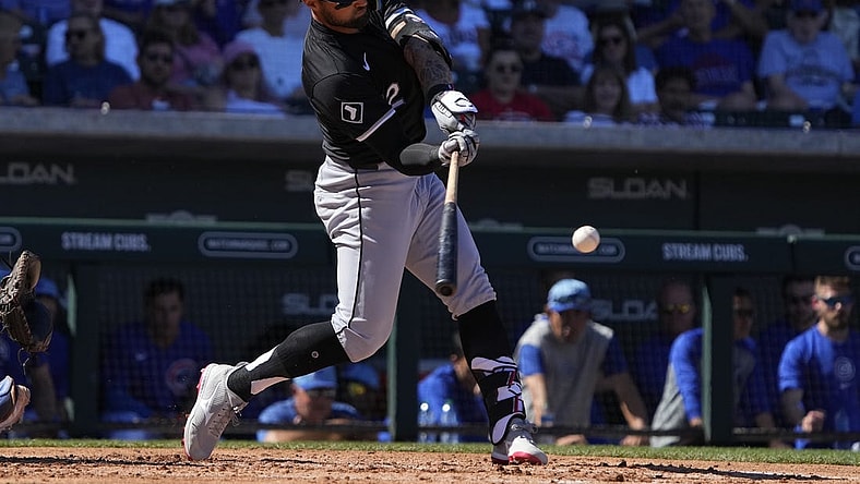 Mar 1, 2024; Mesa, Arizona, USA; Chicago White Sox right fielder Kevin Pillar (12) hits a double against the Chicago Cubs during the third inning at Sloan Park. Mandatory Credit: Rick Scuteri-USA TODAY Sports
