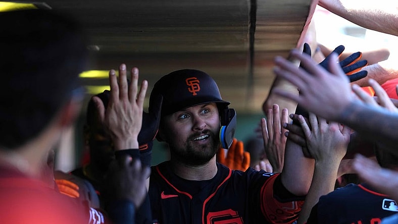 Mar 1, 2024; Scottsdale, Arizona, USA; San Francisco Giants first baseman J.D. Davis (7) celebrates with teammates after hitting a home run against the Texas Rangers during the second inning at Scottsdale Stadium. Mandatory Credit: Joe Camporeale-USA TODAY Sports