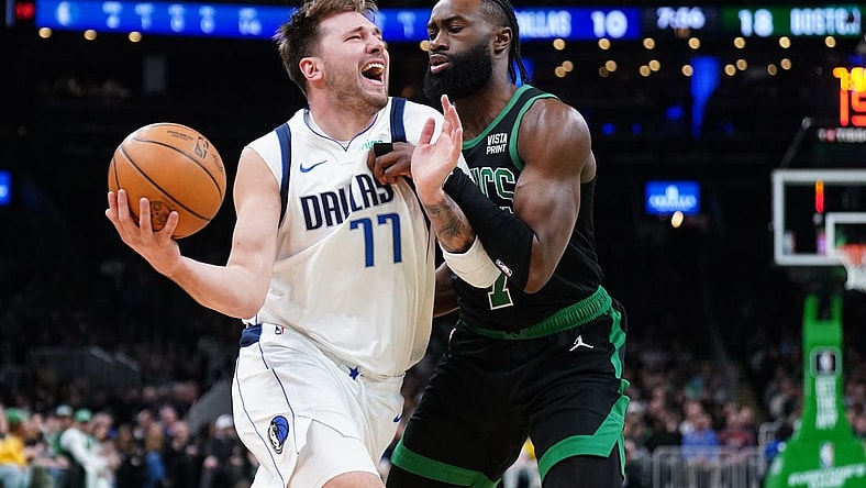Mar 1, 2024; Boston, Massachusetts, USA; Dallas Mavericks guard Luka Doncic (77) drives the ball against Boston Celtics guard Jaylen Brown (7) in the first quarter at TD Garden. Mandatory Credit: David Butler II-USA TODAY Sports