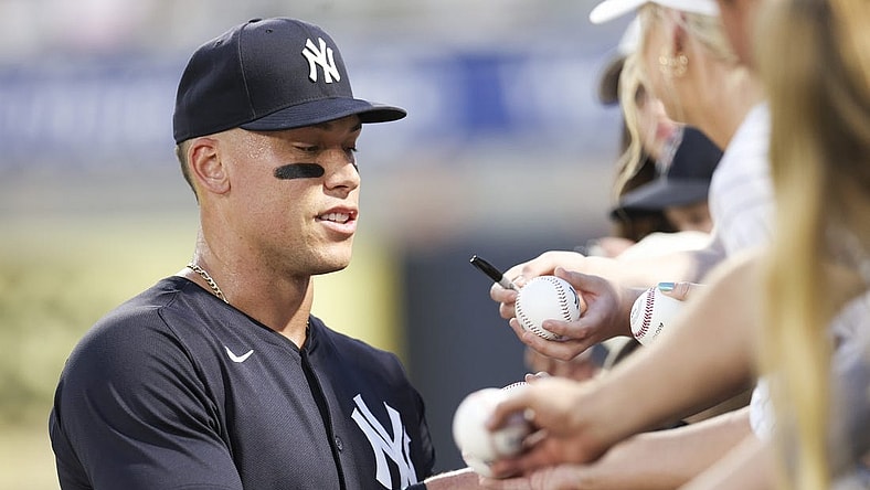 Mar 1, 2024; Tampa, Florida, USA; New York Yankees center fielder Aaron Judge (99) signs autographs before a game against the Toronto Blue Jays at George M. Steinbrenner Field. Mandatory Credit: Nathan Ray Seebeck-USA TODAY Sports
