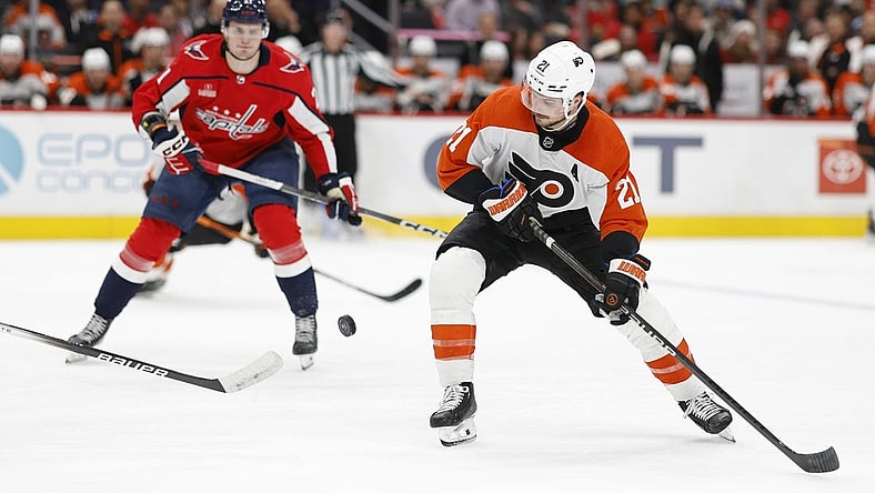 Mar 1, 2024; Washington, District of Columbia, USA; Philadelphia Flyers center Scott Laughton (21) skates with the puck as Washington Capitals center Aliaksei Protas (21) chases in the second period at Capital One Arena. Mandatory Credit: Geoff Burke-USA TODAY Sports