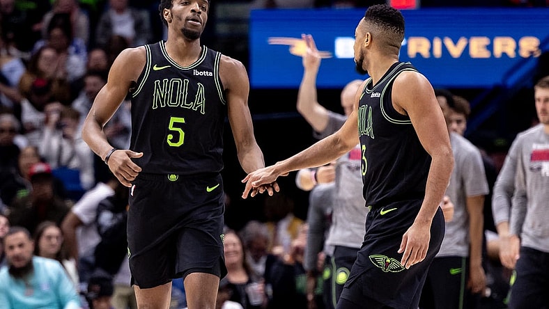 Mar 1, 2024; New Orleans, Louisiana, USA;  New Orleans Pelicans forward Herbert Jones (5) slaps hands with guard CJ McCollum (3) after a play against the Indiana Pacers during the first half at Smoothie King Center. Mandatory Credit: Stephen Lew-USA TODAY Sports