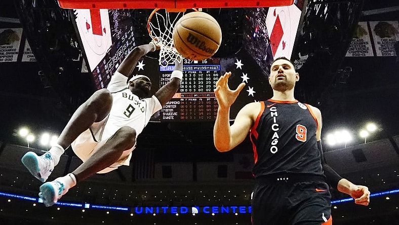 Mar 1, 2024; Chicago, Illinois, USA; Milwaukee Bucks forward Bobby Portis (9) dunks the ball as Chicago Bulls center Nikola Vucevic (9) stands nearby during the first quarter at United Center. Mandatory Credit: David Banks-USA TODAY Sports
