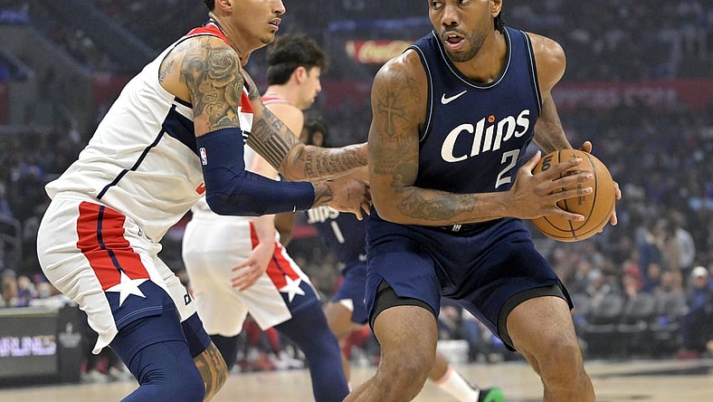 Mar 1, 2024; Los Angeles, California, USA; Los Angeles Clippers forward Kawhi Leonard (2) is defended by Washington Wizards forward Kyle Kuzma (33) in the first half at Crypto.com Arena. Mandatory Credit: Jayne Kamin-Oncea-USA TODAY Sports