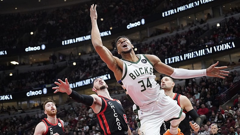 Mar 1, 2024; Chicago, Illinois, USA; Chicago Bulls guard Alex Caruso (6) fouls Milwaukee Bucks forward Giannis Antetokounmpo (34) during the second half at United Center. Mandatory Credit: David Banks-USA TODAY Sports