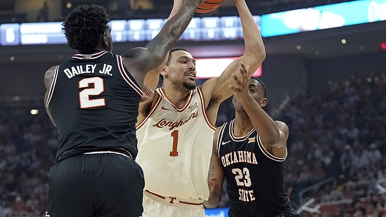 Mar 2, 2024; Austin, Texas, USA; Texas Longhorns forward Dylan Disu (1) drives to the basket while defended by Oklahoma State Cowboys center Brandon Garrison (23) and guard Eric Dailey Jr. (2) during the first half at Moody Center. Mandatory Credit: Scott Wachter-USA TODAY Sports