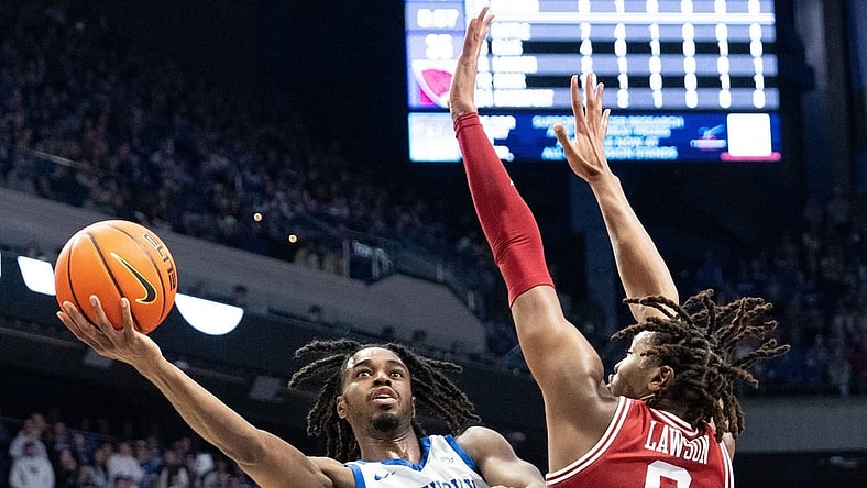 Kentucky Wildcats guard Antonio Reeves (12) goes for a layup against Arkansas Razorbacks forward Chandler Lawson (8) during their game on Saturday, March 2, 2024 at Rupp Arena.