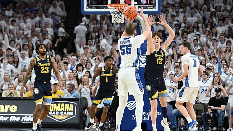 Mar 2, 2024; Omaha, Nebraska, USA; Creighton Bluejays guard Baylor Scheierman (55) scores a three point basket against Marquette Golden Eagles forward Ben Gold (12) in the first half at CHI Health Center Omaha. Mandatory Credit: Steven Branscombe-USA TODAY Sports