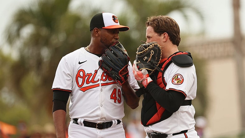 Mar 2, 2024; Sarasota, Florida, USA; Baltimore Orioles pitcher Julio Teheran (49) talks with catcher Adley Rutschman (35) during the fourth inning against the New York Yankees at Ed Smith Stadium. Mandatory Credit: Kim Klement Neitzel-USA TODAY Sports