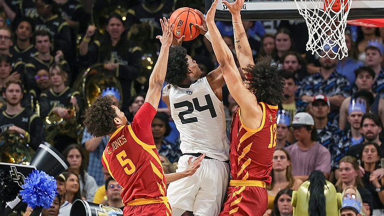 Mar 2, 2024; Orlando, Florida, USA; UCF Knights guard Jaylin Sellers (24) goes to the basket against Iowa State Cyclones guard Curtis Jones (5) and forward Robert Jones (12) during the first half at Addition Financial Arena. Mandatory Credit: Mike Watters-USA TODAY Sports