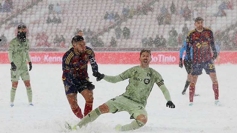 Mar 2, 2024; Sandy, Utah, USA; LAFC defender Ryan Hollingshead (24) is taken down by Real Salt Lake forward Cristian Arango (9) at America First Field. Mandatory Credit: Rob Gray-USA TODAY Sports