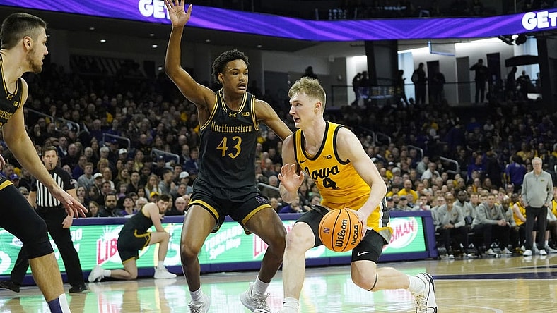 Mar 2, 2024; Evanston, Illinois, USA; Northwestern Wildcats guard Blake Smith (43) defends Iowa Hawkeyes guard Josh Dix (4) during the first half at Welsh-Ryan Arena. Mandatory Credit: David Banks-USA TODAY Sports