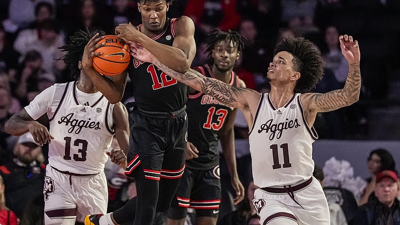 Mar 2, 2024; Athens, Georgia, USA; Georgia Bulldogs forward Matthew-Alexander Moncrieffe (12) grabs a rebound in front of Texas A&M Aggies forward Andersson Garcia (11) during the first half at Stegeman Coliseum. Mandatory Credit: Dale Zanine-USA TODAY Sports