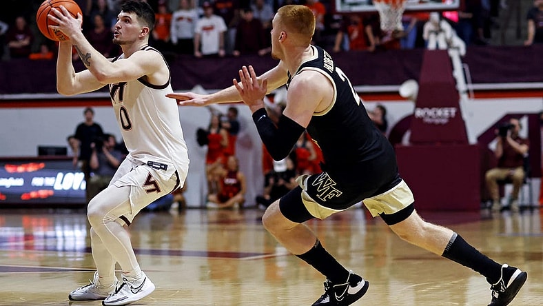 Mar 2, 2024; Blacksburg, Virginia, USA; Virginia Tech Hokies guard Hunter Cattoor (0) shoots the ball against Wake Forest Demon Deacons guard Cameron Hildreth (2) during the second half at Cassell Coliseum. Mandatory Credit: Peter Casey-USA TODAY Sports