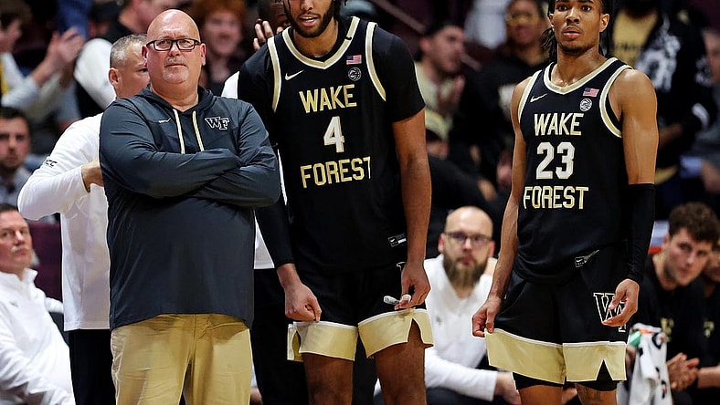 Mar 2, 2024; Blacksburg, Virginia, USA; Wake Forest Demon Deacons head coach Steve Forbes talks with Wake Forest Demon Deacons forward Efton Reid III (4) and guard Hunter Sallis (23) during the second half of the game against the Virginia Tech Hokies at Cassell Coliseum. Mandatory Credit: Peter Casey-USA TODAY Sports