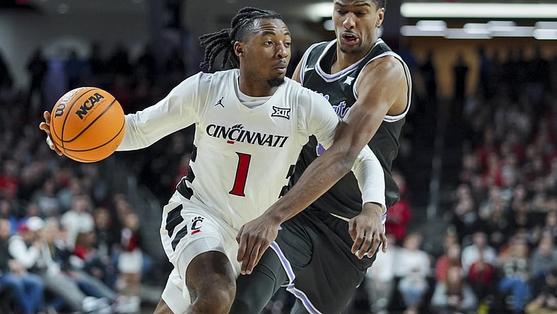Mar 2, 2024; Cincinnati, Ohio, USA;  Cincinnati Bearcats guard Day Day Thomas drives to the basket against Kansas State Wildcats forward David N'Guessan (1) in the first half at Fifth Third Arena. Mandatory Credit: Aaron Doster-USA TODAY Sports