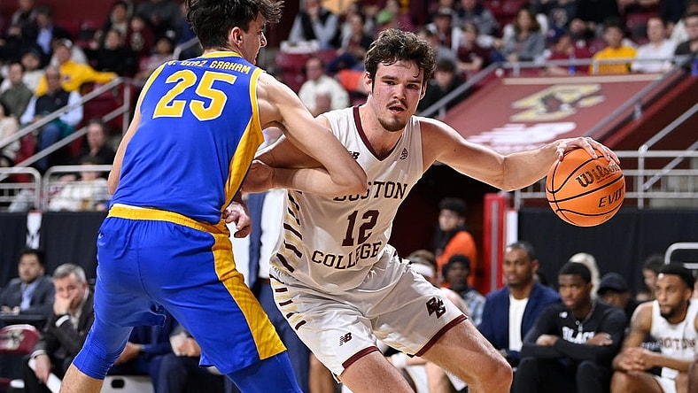 Mar 2, 2024; Chestnut Hill, Massachusetts, USA; Boston College Eagles forward Quinten Post (12) drives to the basket against Pittsburgh Panthers forward Guillermo Diaz Graham (25) during the second half at Conte Forum. Mandatory Credit: Eric Canha-USA TODAY Sports