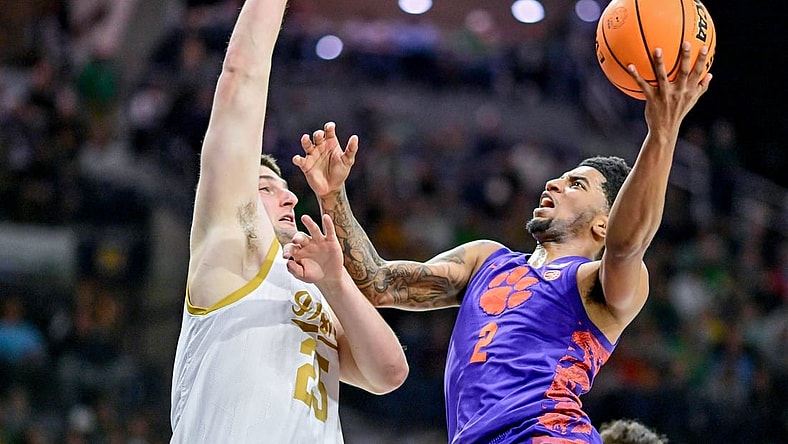 Mar 2, 2024; South Bend, Indiana, USA; Clemson Tigers guard Dillon Hunter (2) goes up for a shot as Notre Dame Fighting Irish forward Matt Zona (25) defends in the first half at the Purcell Pavilion. Mandatory Credit: Matt Cashore-USA TODAY Sports