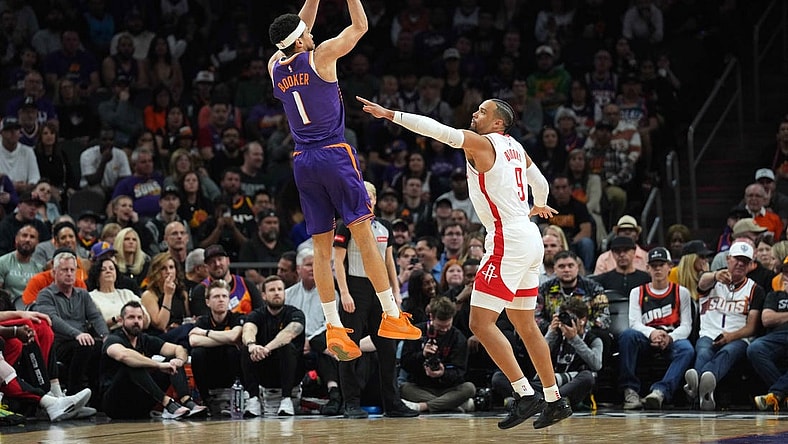 Mar 2, 2024; Phoenix, Arizona, USA; Phoenix Suns guard Devin Booker (1) shoots over Houston Rockets forward Dillon Brooks (9) during the first half at Footprint Center. Mandatory Credit: Joe Camporeale-USA TODAY Sports