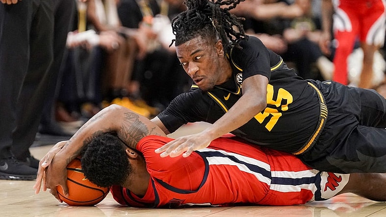 Mar 2, 2024; Columbia, Missouri, USA; Mississippi Rebels guard Brandon Murray (0) and Missouri Tigers guard Sean East II (55) scramble for a loose ball during the first half at Mizzou Arena. Mandatory Credit: Denny Medley-USA TODAY Sports