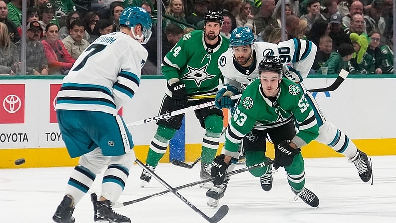Mar 2, 2024; Dallas, Texas, USA;  Dallas Stars center Wyatt Johnston (53) and San Jose Sharks right wing Justin Bailey (90) chase the puck during the second period at American Airlines Center. Mandatory Credit: Chris Jones-USA TODAY Sports