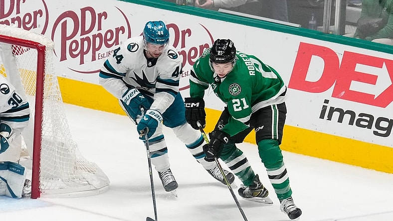 Mar 2, 2024; Dallas, Texas, USA;  Dallas Stars left wing Jason Robertson (21) skates with the puck as San Jose Sharks defenseman Marc-Edouard Vlasic (44) defends during the third period at American Airlines Center. Mandatory Credit: Chris Jones-USA TODAY Sports