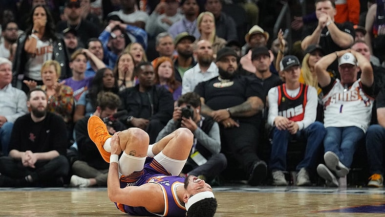 Mar 2, 2024; Phoenix, Arizona, USA; Phoenix Suns guard Devin Booker (1) reacts after being inured against the Houston Rockets during the second half at Footprint Center. Mandatory Credit: Joe Camporeale-USA TODAY Sports