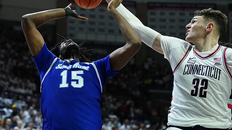 Mar 3, 2024; Storrs, Connecticut, USA; UConn Huskies center Donovan Clingan (32) blocks the shot of Seton Hall Pirates center Jaden Bediako (15) in the first half at Harry A. Gampel Pavilion. Mandatory Credit: David Butler II-USA TODAY Sports
