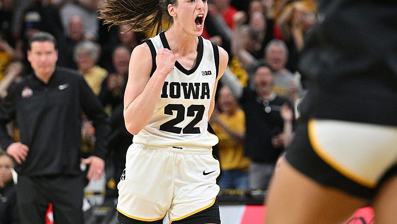 Mar 3, 2024; Iowa City, Iowa, USA; Iowa Hawkeyes guard Caitlin Clark (22) reacts after breaking the NCAA basketball all-time scoring record during the second quarter against the Ohio State Buckeyes. Mandatory Credit: Jeffrey Becker-USA TODAY Sports