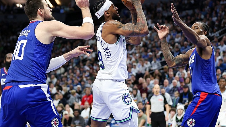 Mar 3, 2024; Minneapolis, Minnesota, USA; Minnesota Timberwolves guard Nickeil Alexander-Walker (9) shoots as LA Clippers center Ivica Zubac (40) and LA Clippers forward Kawhi Leonard (2) defend during the first half at Target Center. Mandatory Credit: Matt Krohn-USA TODAY Sports
