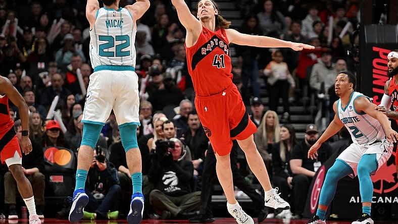 Mar 3, 2024; Toronto, Ontario, CAN;  Charlotte Hornets guard Vasa Micic (22) shoots the ball as Toronto Raptors center Kelly Olynyk (41) defends in the first half at Scotiabank Arena. Mandatory Credit: Dan Hamilton-USA TODAY Sports