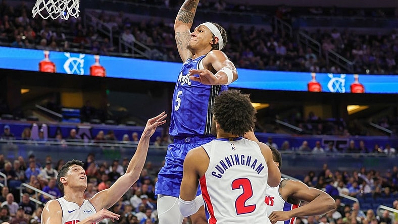 Mar 3, 2024; Orlando, Florida, USA; Orlando Magic forward Paolo Banchero (5) dunks against Detroit Pistons forward Simone Fontecchio (19) during the second quarter at KIA Center. Mandatory Credit: Mike Watters-USA TODAY Sports
